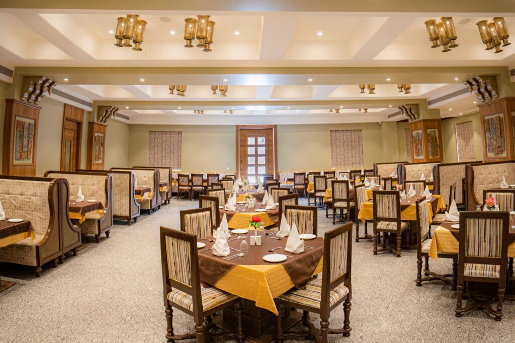 Spacious multi-cuisine restaurant with elegant seating and warm interiors at Marugarh Jodhpur.